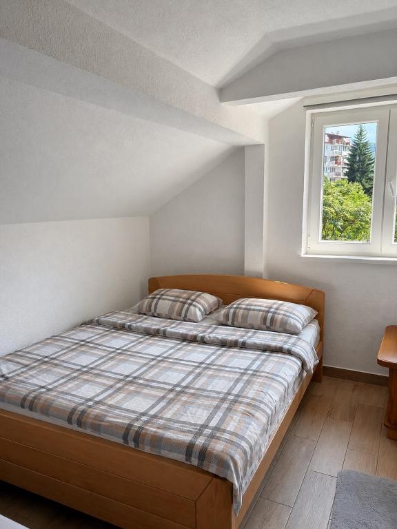 a bedroom with a bed and a window at Harmony apartment in Foča
