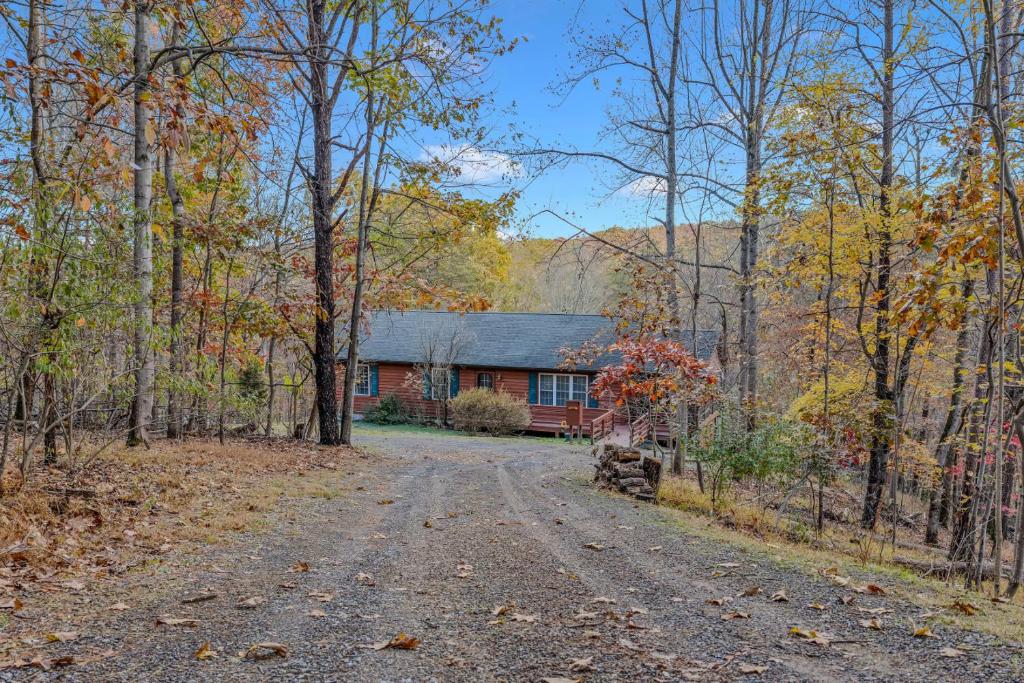 a road leading to a house in the woods at Creekview Cabin - Hot Tub, EV Station, Pet Friendly, Screen Porch, Wifi, Grill, Fire Pit, Deck, Family Friendly, Game Room, King Bed in Morton Grove