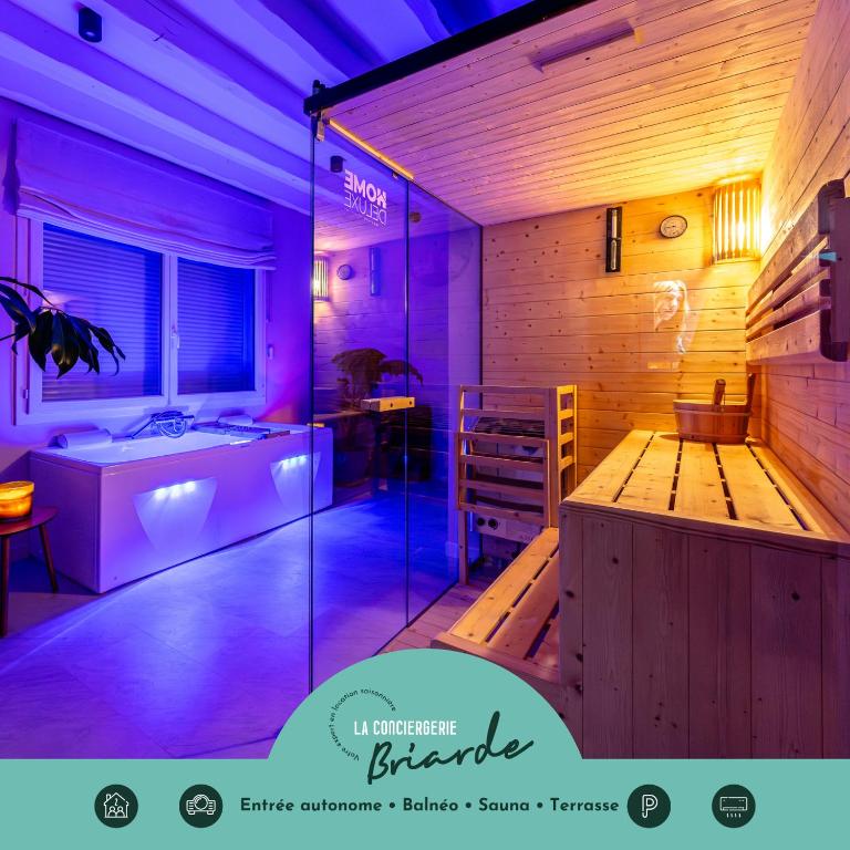 a bathroom with a bath tub and a sink at La Bali, Luxe et relaxation in La Ferté-Gaucher