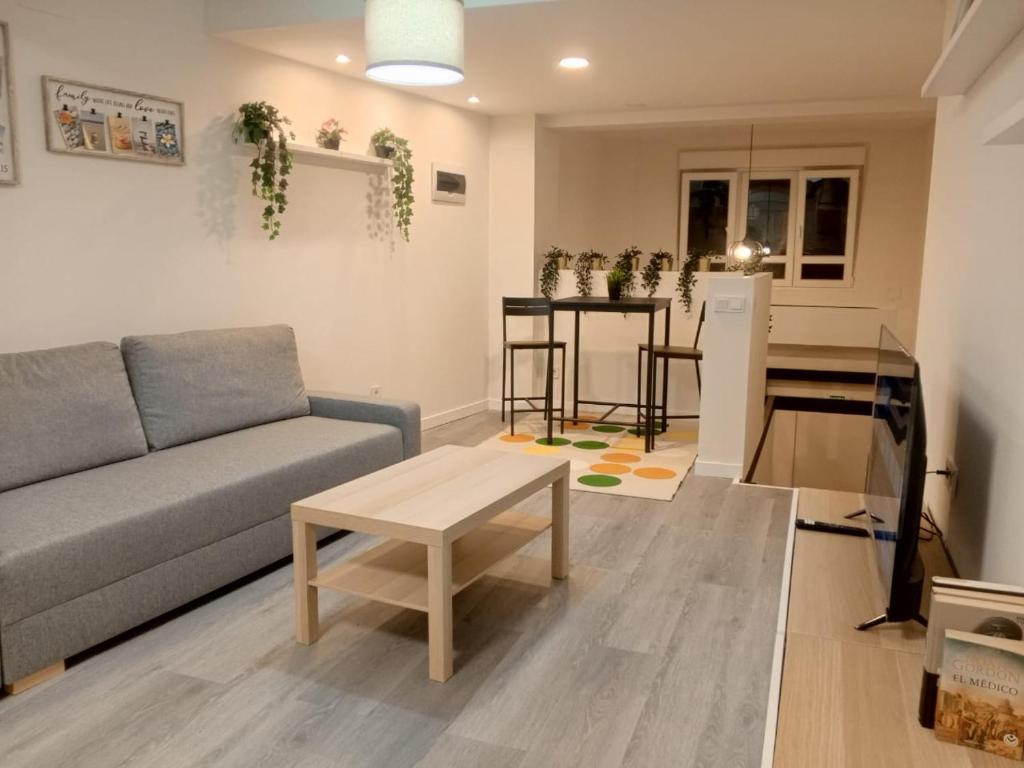 a living room with a couch and a table at Estudios 71 Sardinero RH - Santander in Santander