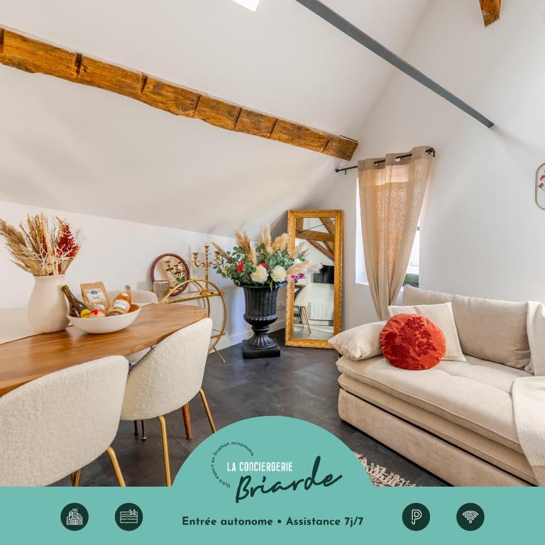 a living room with a couch and a table at L'authentique, Chic, relaxant et entrée autonome in Coulommiers
