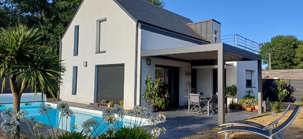 a house with a swimming pool in front of it at Lann Raz in Sarzeau