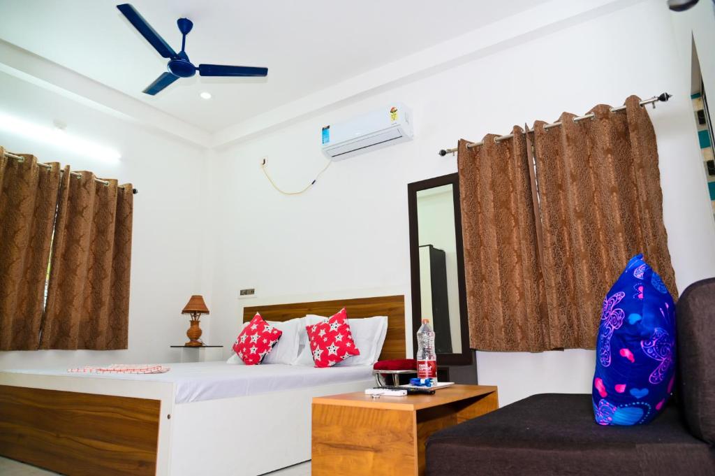 a room with a bed and a chair and a mirror at Diya Homestay in Rāmpur Hāt