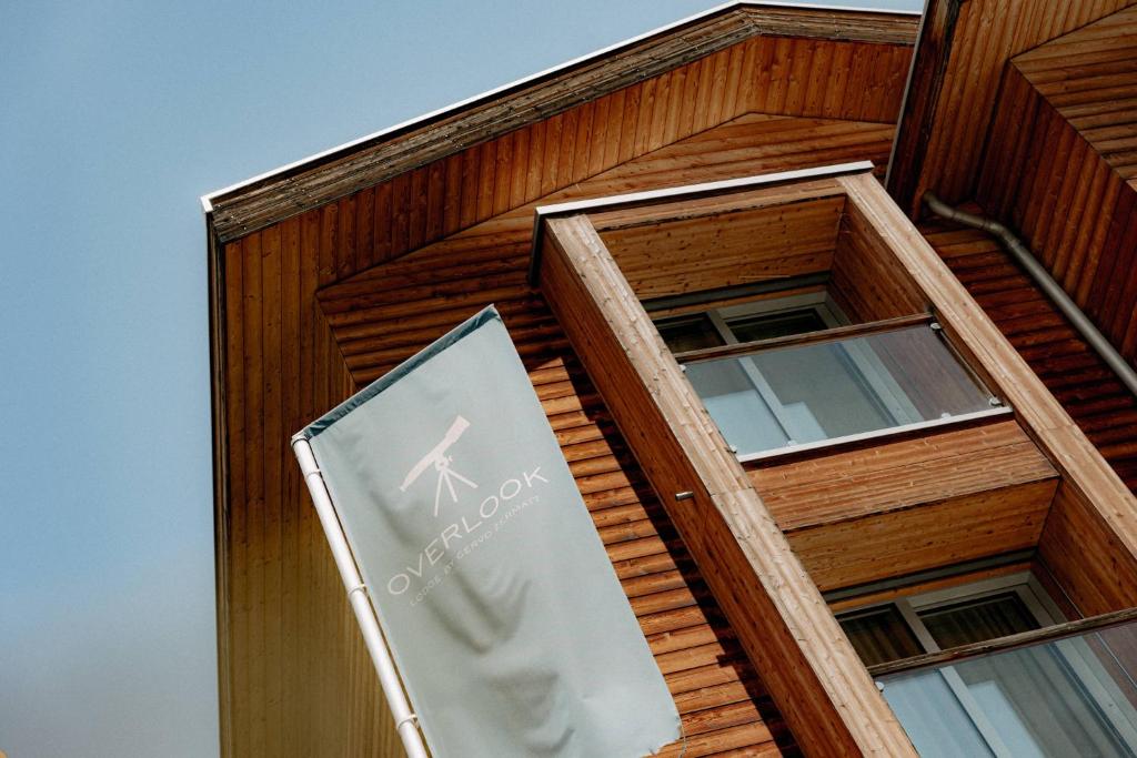 a store sign on the side of a building at OVERLOOK Lodge by CERVO Zermatt in Zermatt