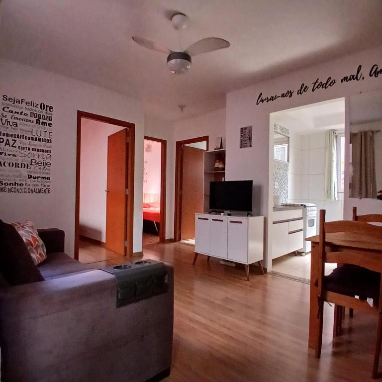 a living room with a couch and a table at Apartamento Aconchegante! in Uberaba