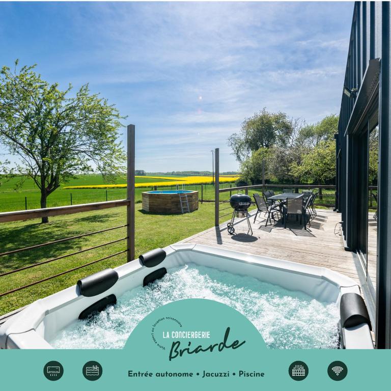a jacuzzi tub in the backyard of a house at L'Evasion, Piscine et jacuzzi in Lescherolles