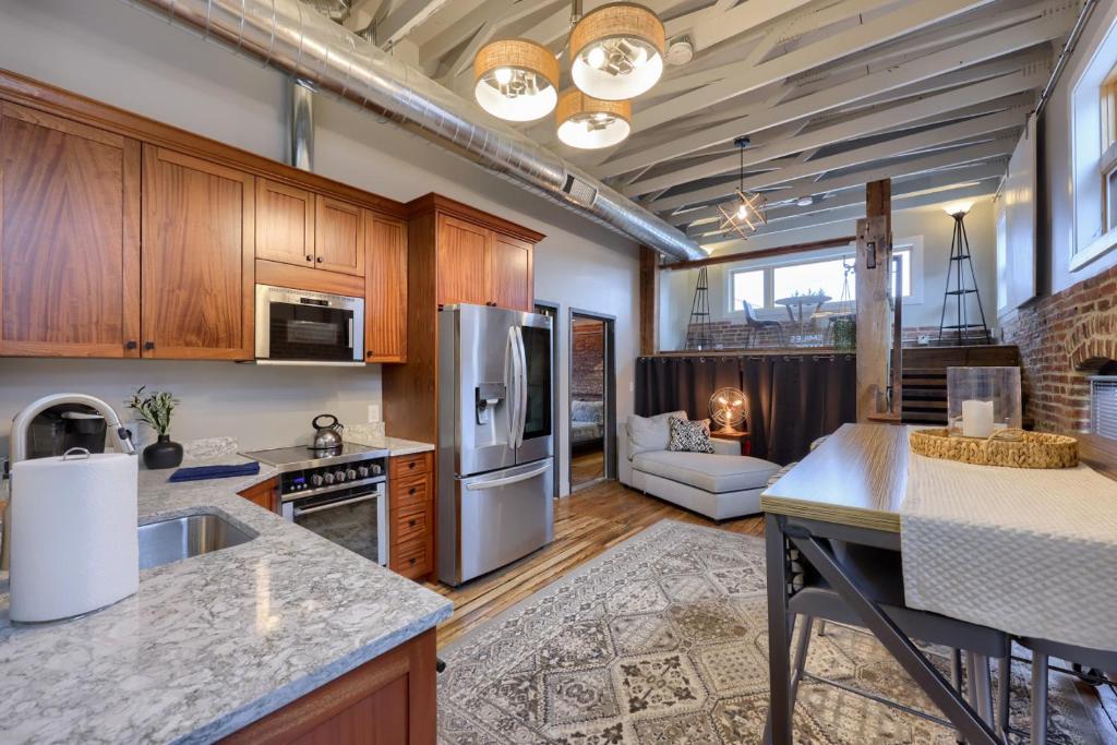 a kitchen with stainless steel appliances and a living room at Sweet Lancaster Apt. A in Lancaster