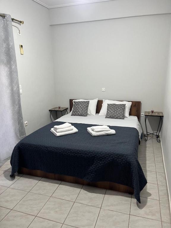 a bedroom with a bed with two towels on it at Efie's cozy home in Missolonghi