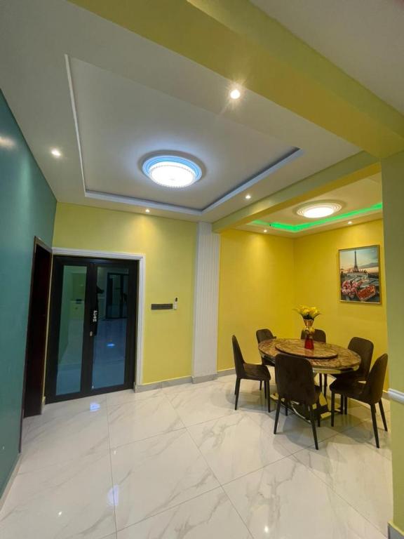 a dining room with a table and chairs at Suite premium in Douala