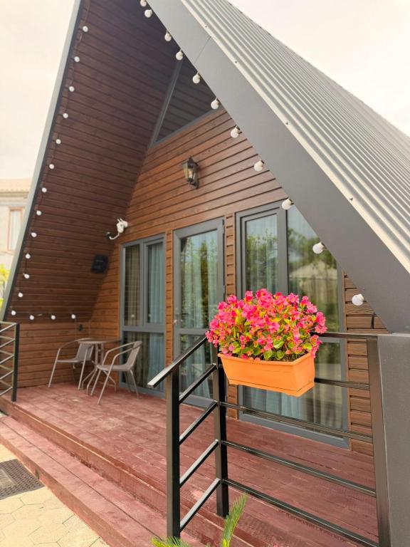 a deck with a pot of flowers on a house at Ananta in Kobuleti