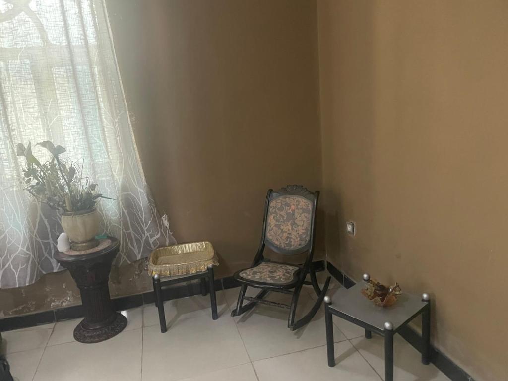 a room with two chairs and a table and a window at Djilani Global Hub in Dirē Dawa