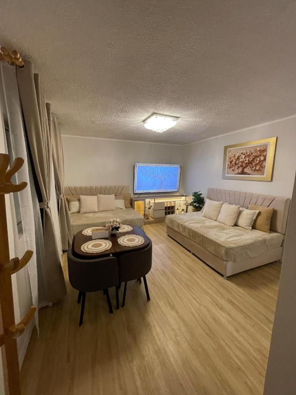 a living room with a couch and a table at Mini Apartment Ares 3 in Lima