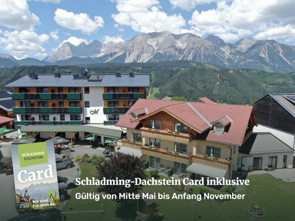 arial view of a building with mountains in the background at Hotel Moser in Schladming
