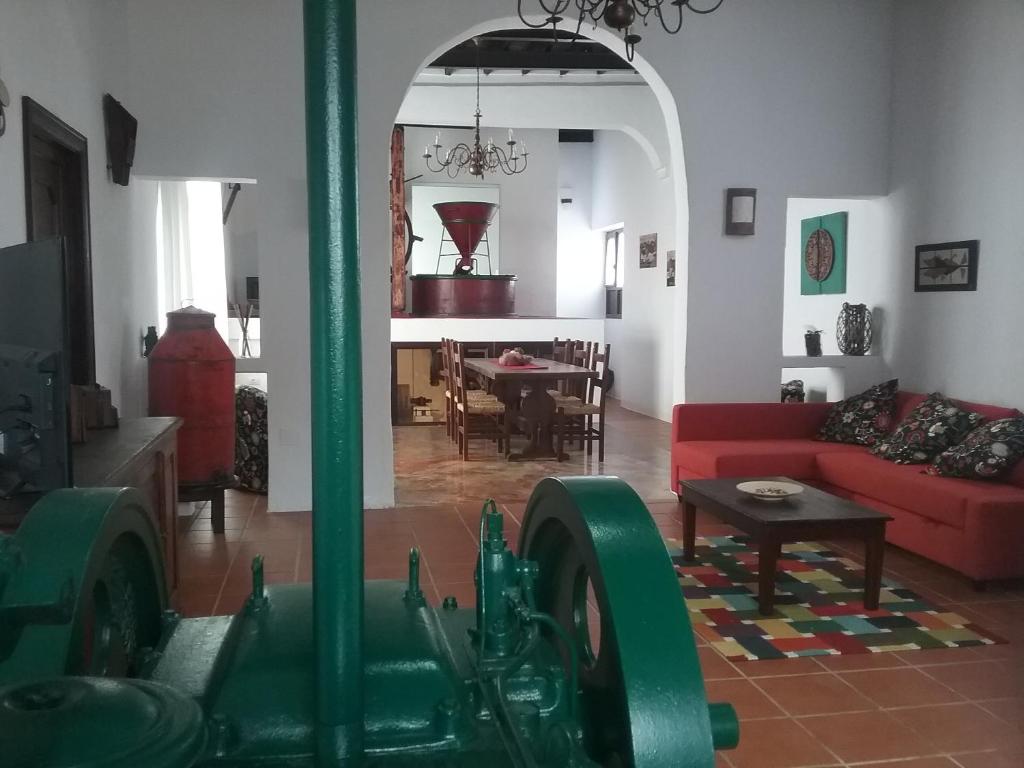 a living room with a red couch and a table at Casa Rural "La Molina" in Máguez