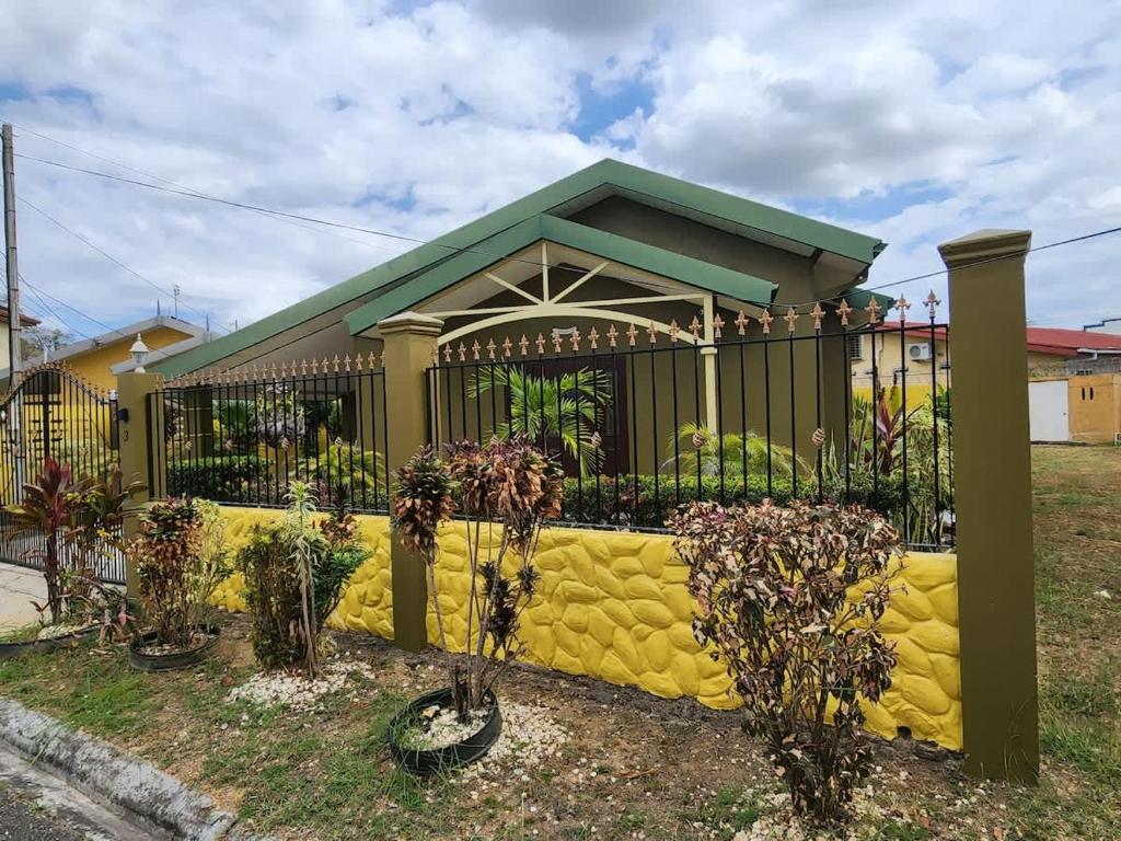 a yellow fence in front of a house at Alluring Ambrosia in Arouca