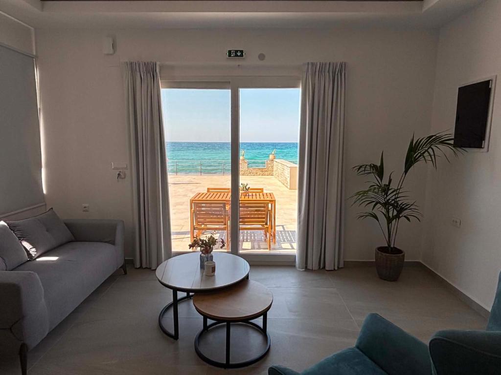 a living room with a couch and a table at Socrates Seaside Apartments in Milatos