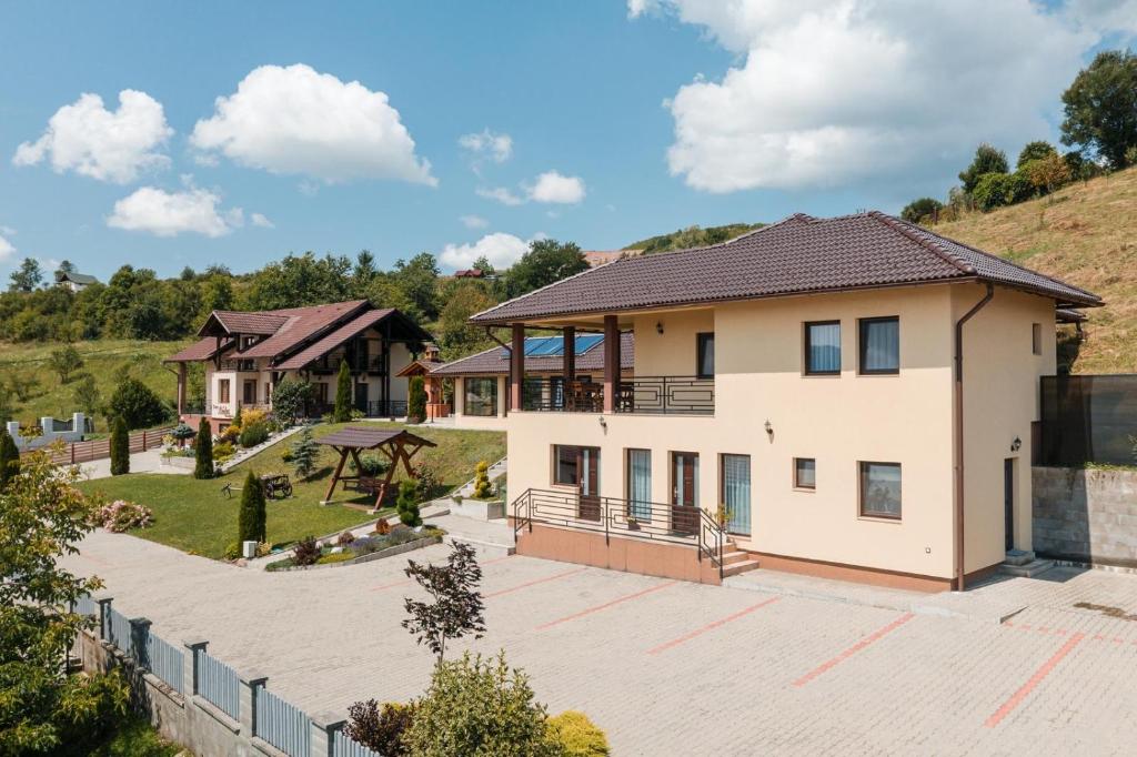 a house with a large driveway in front at Casa Leda in Sovata