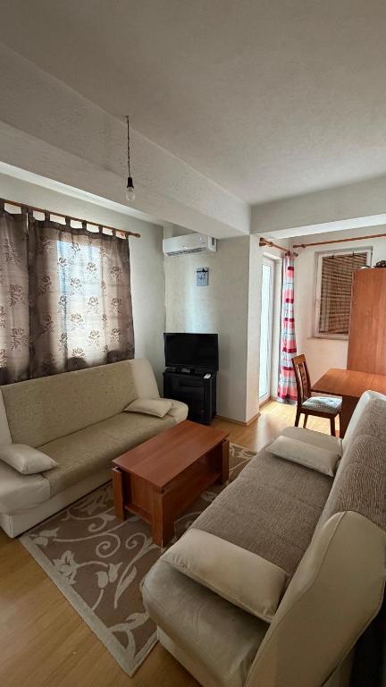 a living room with two couches and a coffee table at Coolbnb Apartment Tetovo in Tetovo