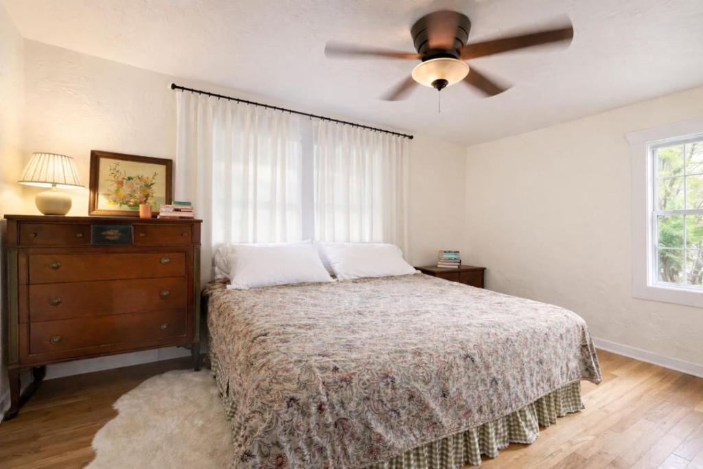 a bedroom with a bed and a ceiling fan at Live Oak Home with Garden Studio in Gainesville