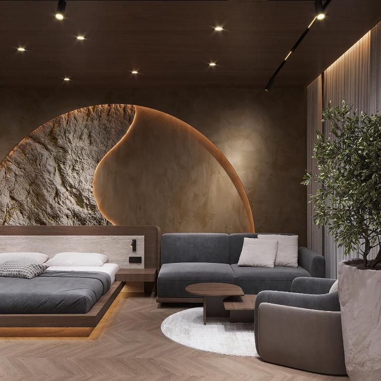 a living room with two blue couches and a table at Boutique Hotel by Ruci in Terihat