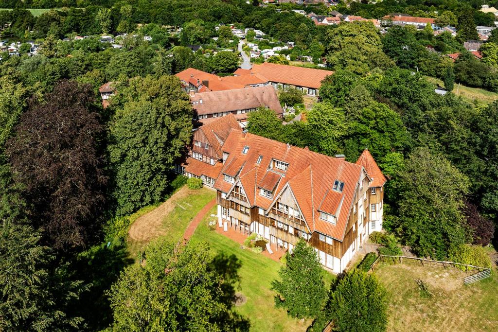 an aerial view of a large house on a hill at Romantik Hotel Hof zur Linde in Münster
