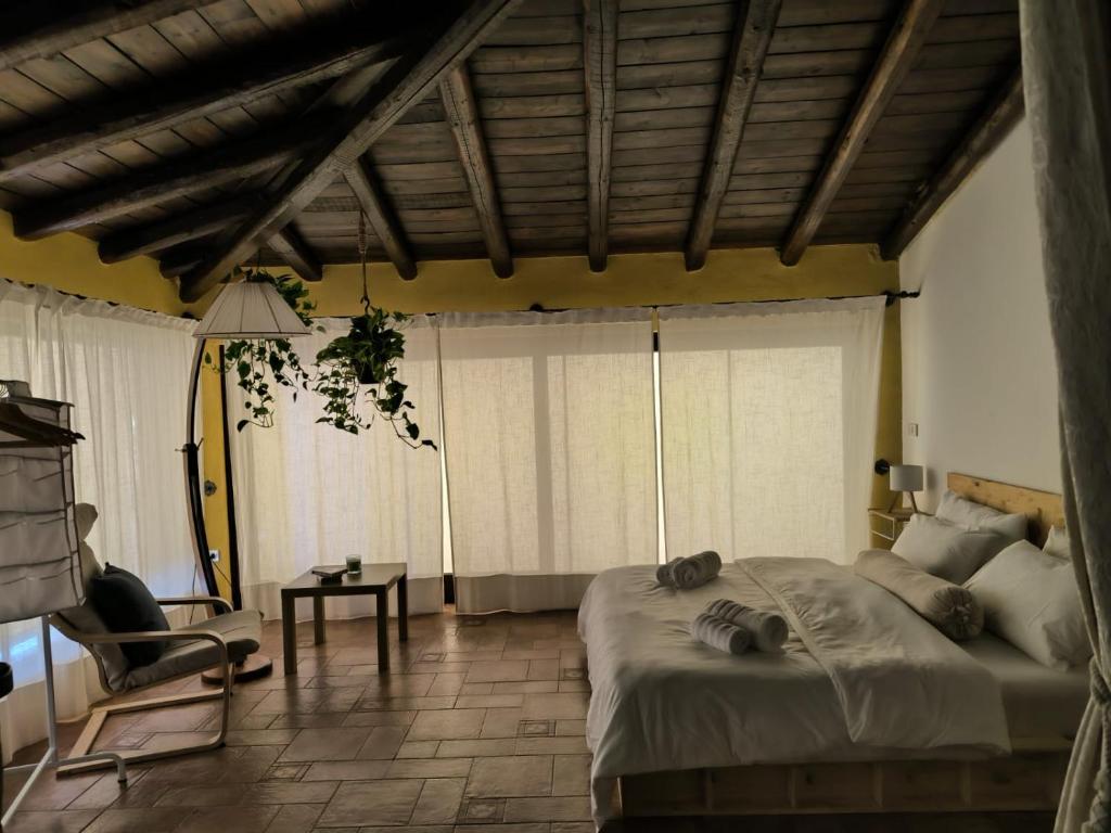 a bedroom with a large bed in a room with windows at Il Giardino del Belvedere in Barrafranca