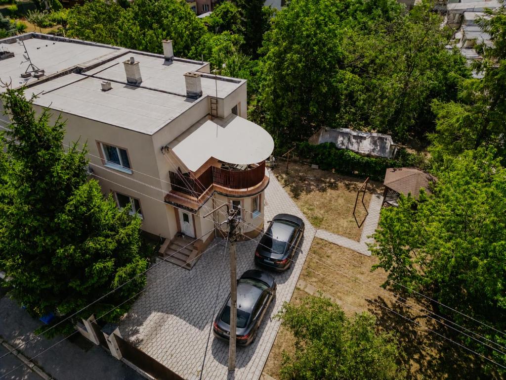 an aerial view of a house with two cars parked in front at Marilyn Apartment in Nitra