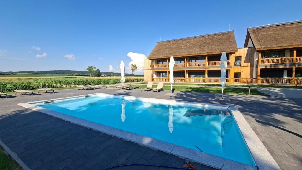 a large swimming pool in front of a building at Butični Hotel Sončno Polje in Moravske-Toplice