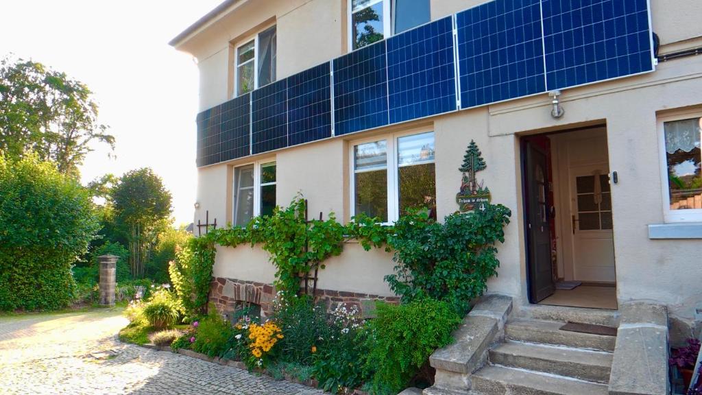 a house with solar panels on the side of it at Ferienwohnung Glück auf in Gornsdorf