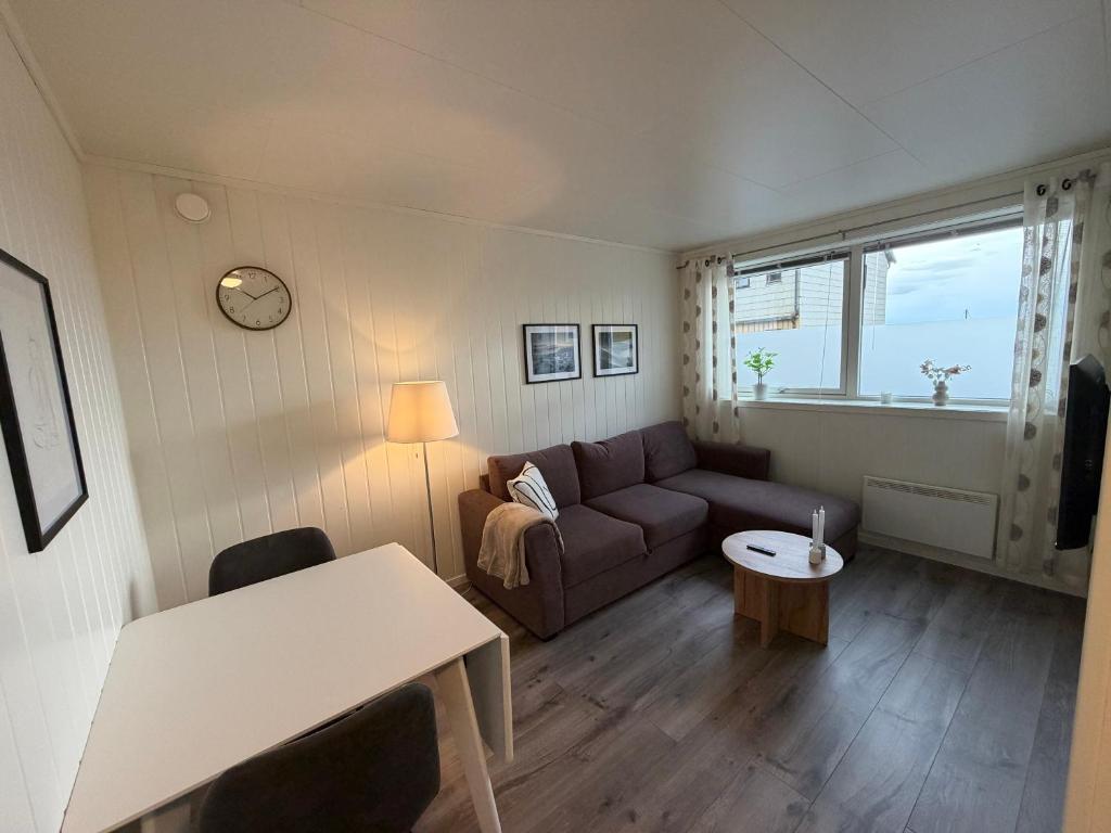 a living room with a couch and a table at Havnegata Apartments in Vadsø
