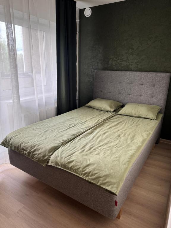 a bed in a bedroom next to a window at Taagepera Guest Apartment in Taagepera