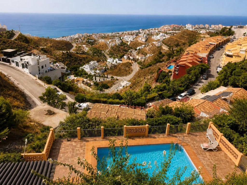 a villa with a swimming pool and a view of the ocean at Torrox costa sea view in Torrox