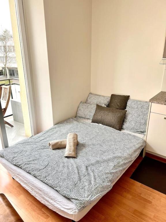 a bedroom with a bed with a towel on it at 2 Room Center Zurich Flats with Balcony - HildaB in Zurich