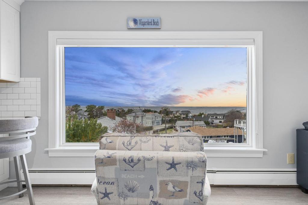 a window in a room with a chair in front of it at Gulls Nest in Gloucester