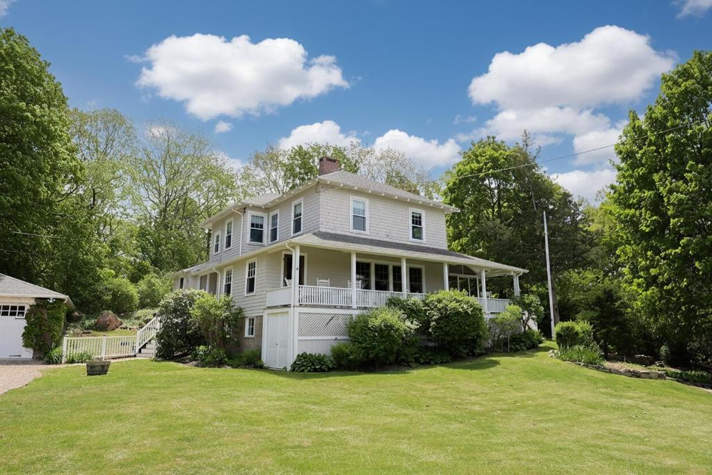 a large white house with a large yard at Tidebend in Gloucester