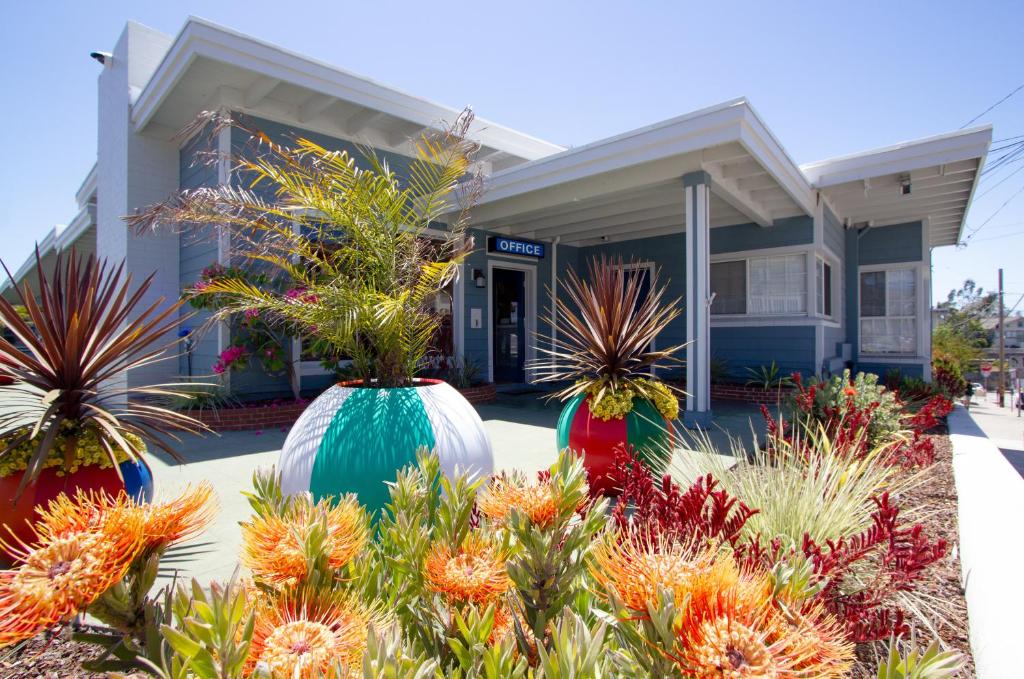 a house with three large vases with plants in front of it at Edgewater Beach Inn in Santa Cruz