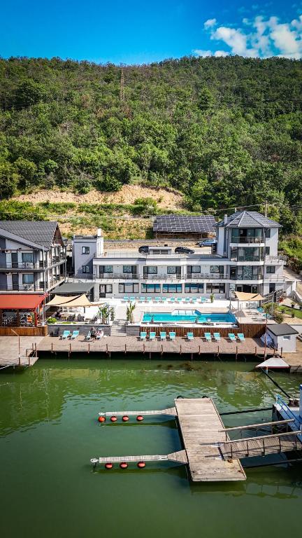 a large building with a dock in the water at CASA 9 - villa & spa in Eşelniţa
