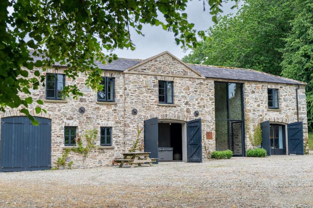 an old stone house with a picnic table in front at The Hayloft in Strabane