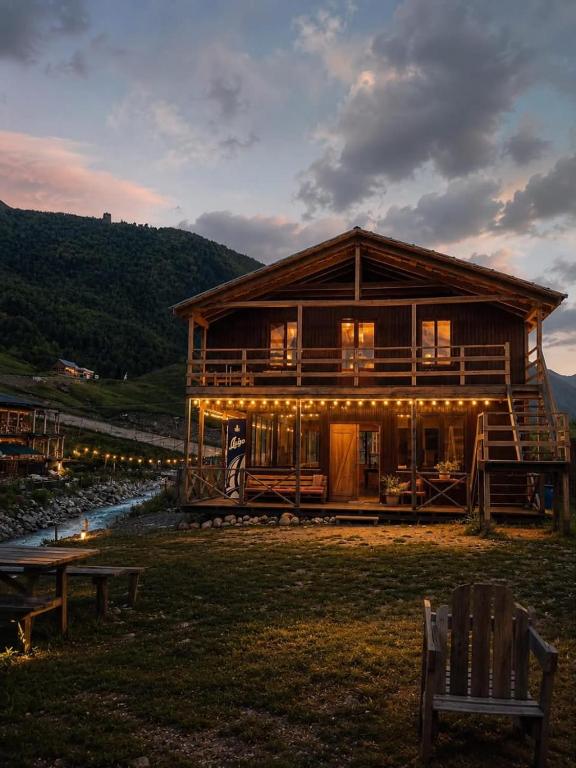 a log cabin with a bench in front of it at Sarag in Ushguli