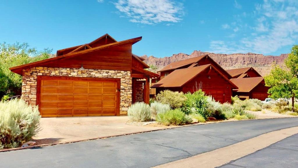 a house with a garage with a mountain in the background at Rim View Retreat #14 in Moab