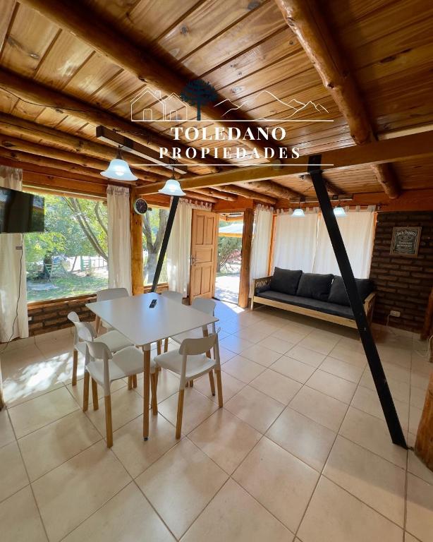 a living room with a table and chairs and a couch at Cielo Azul 4 in Villa Pehuenia