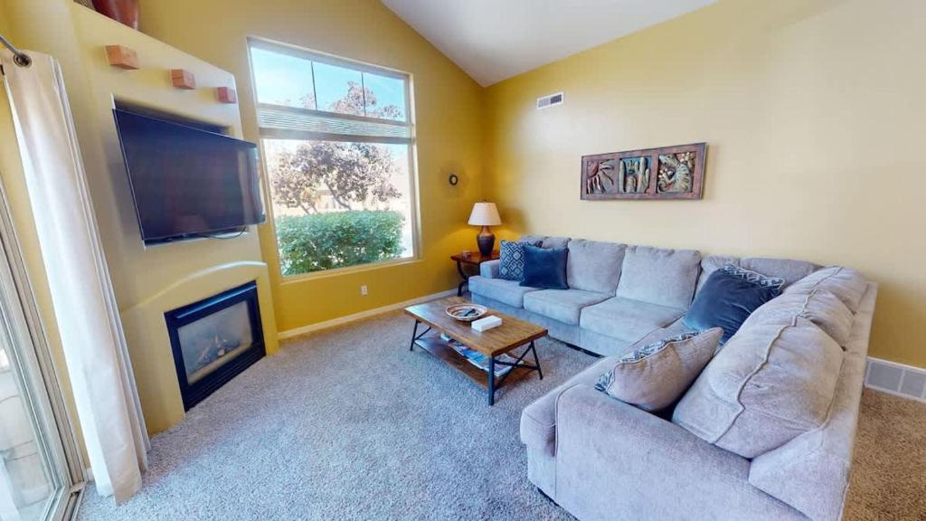 a living room with a couch and a fireplace at Desert Hideaway #C2 in Moab