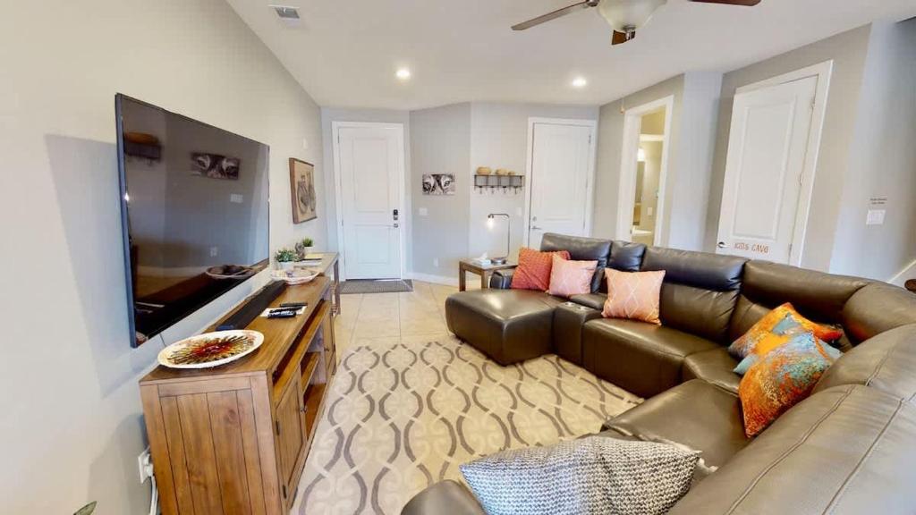 a living room with a couch and a flat screen tv at Entrada at Moab #668 in Moab