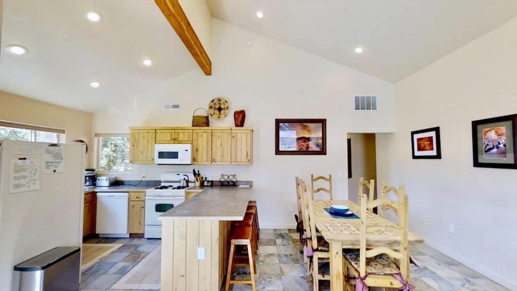 a kitchen with a table and chairs and a refrigerator at Grey Pearl #Q3 in Moab