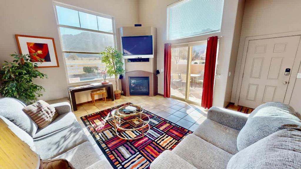 a living room with a couch and a fireplace at Mountain Paradise #G3 in Moab