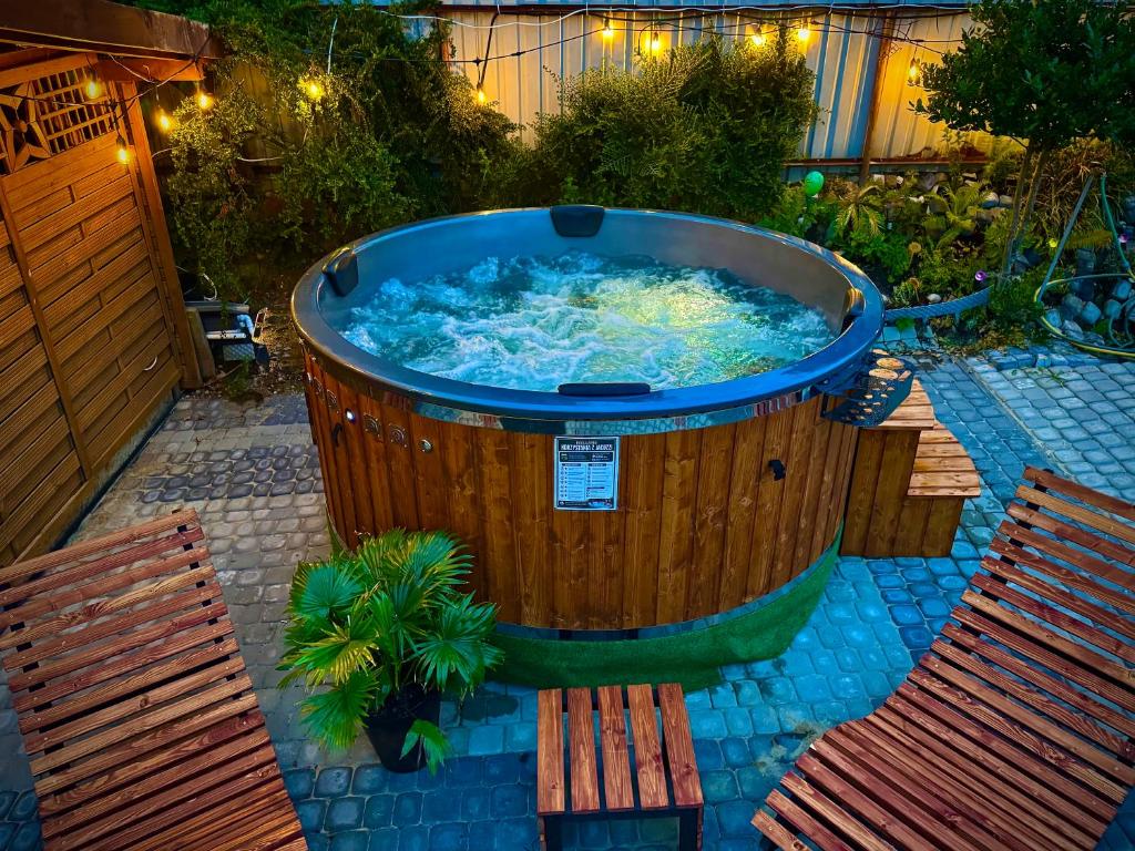 a large hot tub in a yard with two benches at Pensjonat Semida in Władysławowo