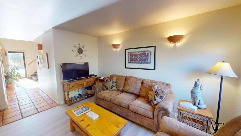 a living room with a couch and a tv at Kokopelli Dream #3251 in Moab