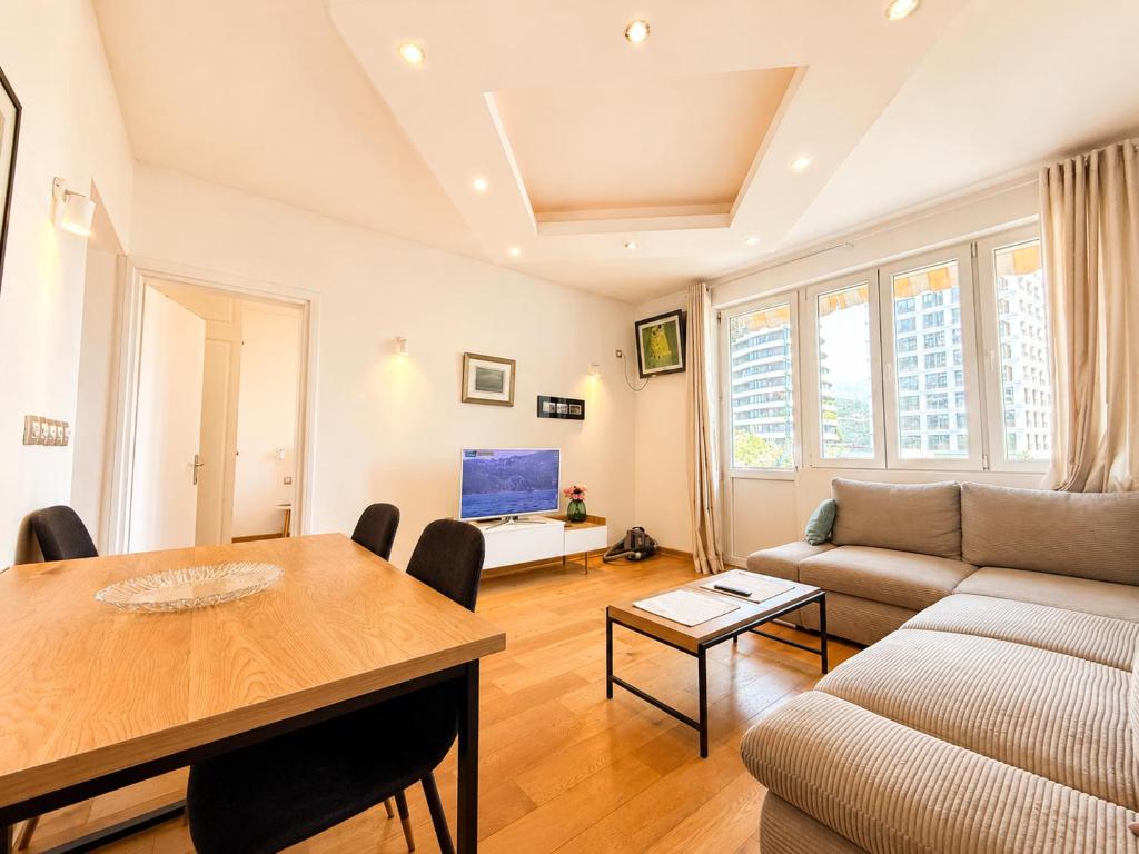 a living room with a table and a couch at Alex Apartments in Budva