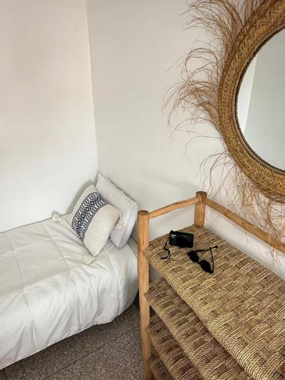 a bedroom with a bed with a mirror and a table at Soul Surf House in Agadir