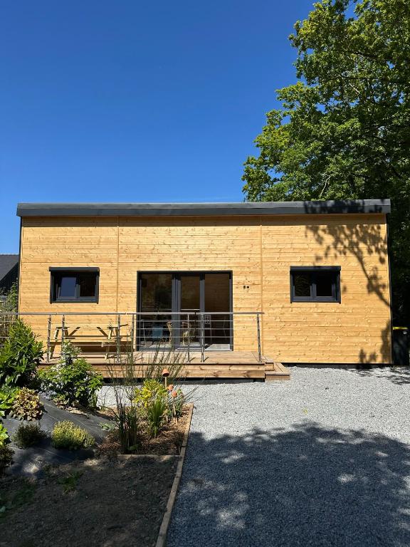 a large yellow building with a ramp in front of it at Le chalet des Marais in Saint-Molf